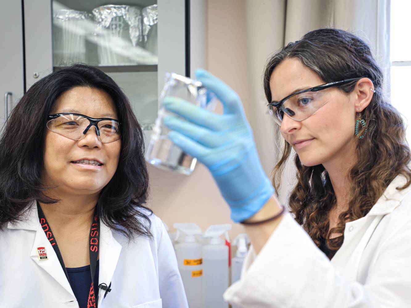 researchers looking at a sample